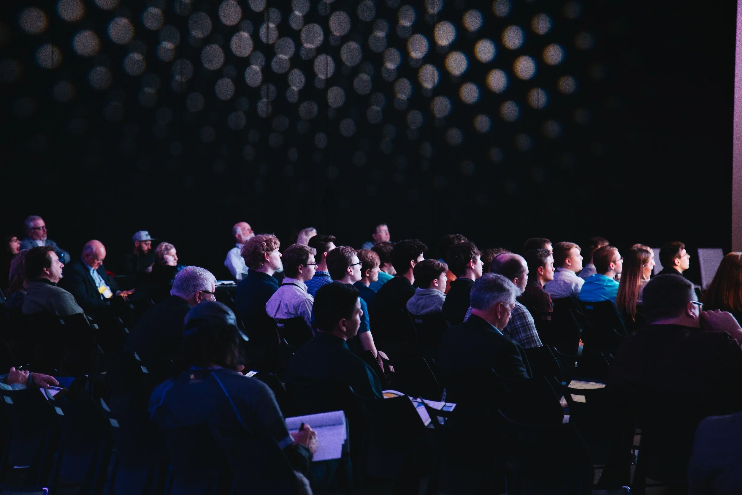 An audience of professionals listening at a business conference